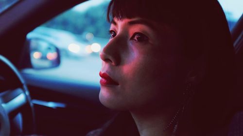 Close-up of thoughtful woman traveling in car