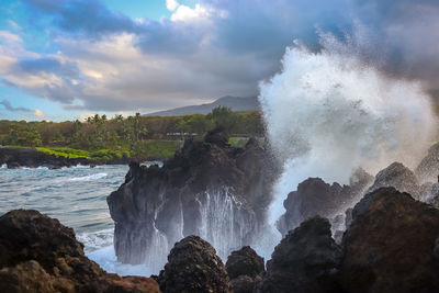 Scenic view of waterfall against sky