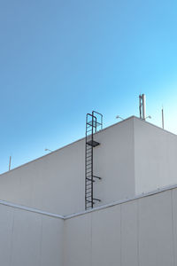 Low angle view of building against clear blue sky