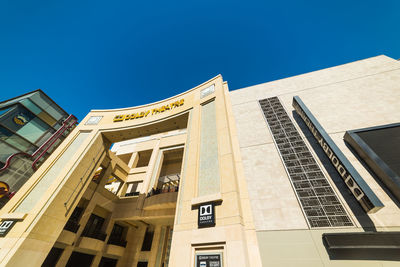 Low angle view of buildings against clear blue sky