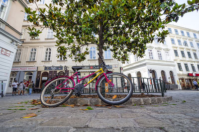 Bicycles on sidewalk by building in city