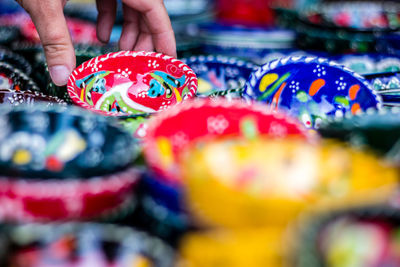 Midsection of person holding multi colored candies for sale