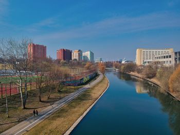 River amidst buildings against sky in city