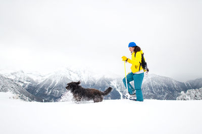 Man with dog in snow