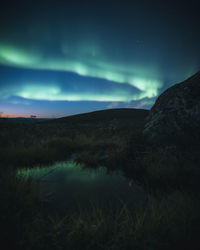 Scenic view of landscape against sky at night