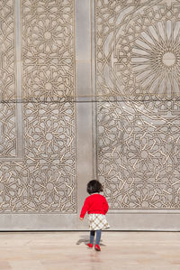 Full length rear view of a woman walking in museum