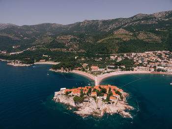 High angle view of sea and mountains against sky