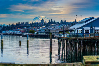 A view of buildings in tacoma, washington with mount rainier behind.