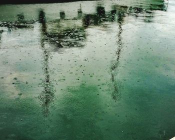 High angle view of raindrops on wet street during monsoon