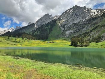 Scenic view of lake and mountains against sky