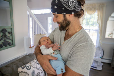 Full length of father and daughter baby