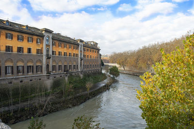 River amidst buildings against sky