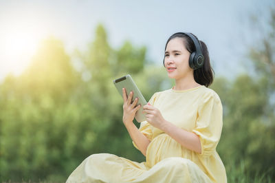 Young woman using smart phone outdoors