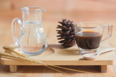 Close-up of black tea and pine cone on table