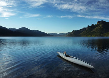 Boats moored in lake against sky