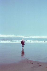 Full length of man on beach against sky