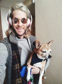 Portrait of smiling man with chihuahua dog