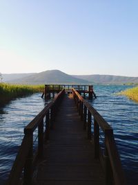 Empty jetty leading to lake