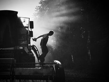 Man on agricultural machinery in farm against sky