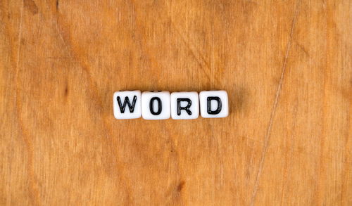 Close-up of information sign on wooden table