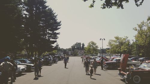 People on street in city against sky