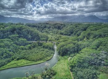 High angle view of river amidst mountains against sky