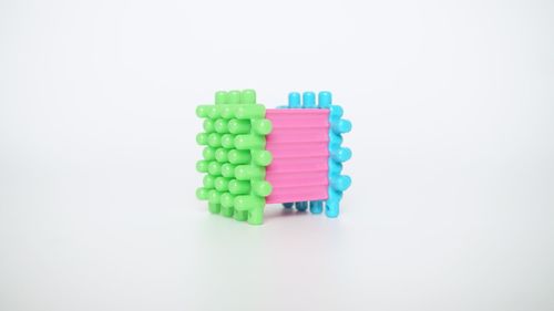 Close-up of multi colored candies against white background