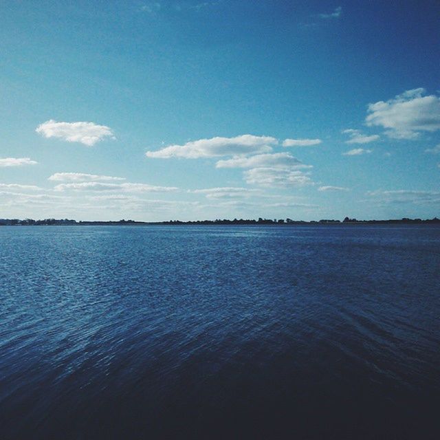 water, tranquil scene, waterfront, tranquility, scenics, sky, blue, sea, beauty in nature, rippled, nature, idyllic, cloud - sky, cloud, calm, outdoors, day, no people, lake, reflection