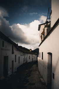 Empty alley amidst buildings in town