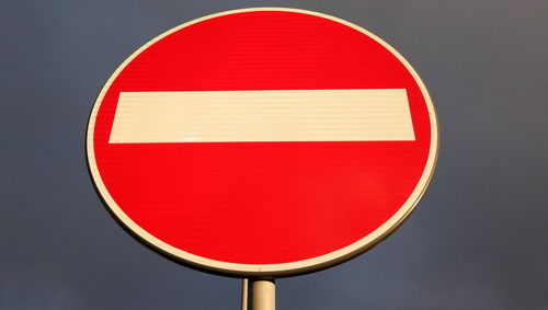 Close-up of road sign against white background