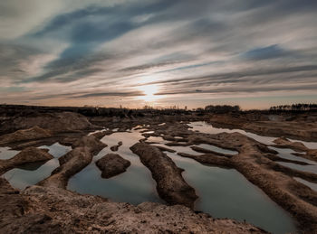 Scenic view of land against sky during sunset