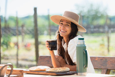 Portrait of young woman drinking coffee