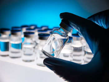 Close-up of hand holding glass against blurred background