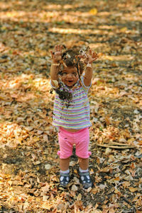 Girl standing on autumn leaves