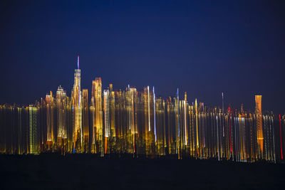 Illuminated buildings in city at night