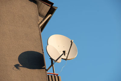 Low angle view of satellite dish  against clear blue sky