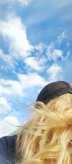 Close-up of person on beach against sky