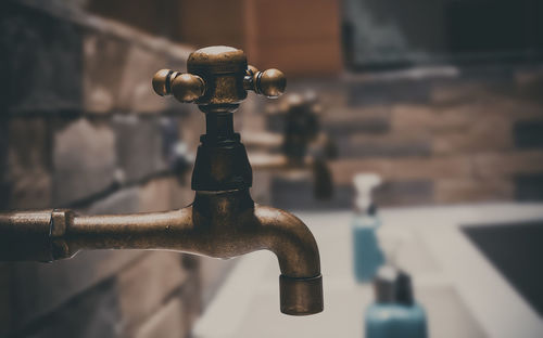 Close-up of faucet in bathroom