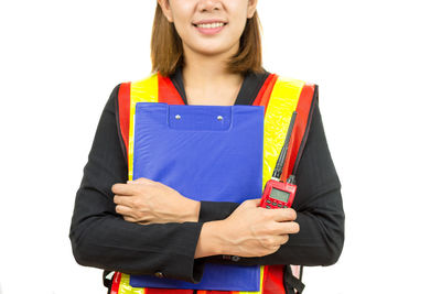 Young woman smiling against white background