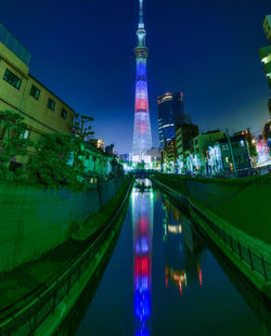 Reflection of illuminated buildings in city at night