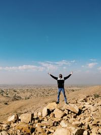 Full length of woman standing on landscape against sky