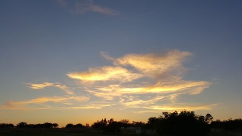 Scenic view of landscape against sky at sunset