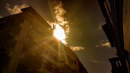 Low angle view of houses against sky during sunset
