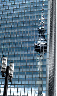 Reflection of fernsehturm tower on glass building