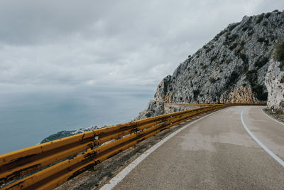 Road by sea against sky