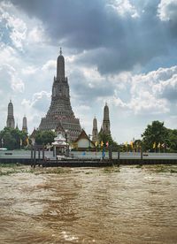 Temple by building against sky