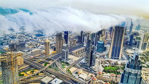 High angle view of modern buildings in city against sky