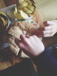 Close-up of hand holding hands at home