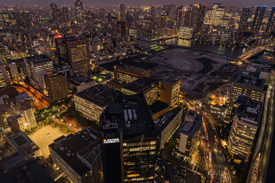 High angle view of illuminated buildings in city at night