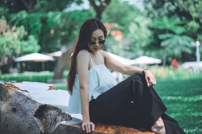 Mid adult woman sitting on rock